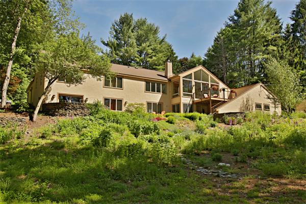 124 South Great Road Lincoln, MA 01773 - Photo 1 of 17 a front view of a house with a yard and trees