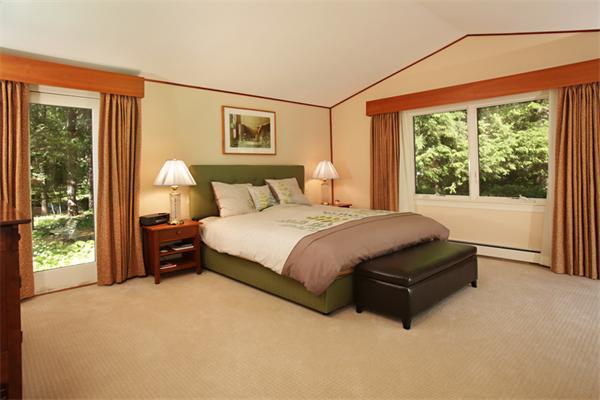 124 South Great Road Lincoln, MA 01773 - Photo 11 of 17 a spacious bedroom with a bed lamp and a large window