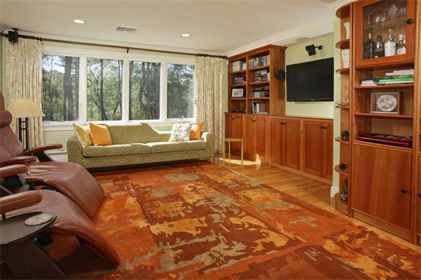 124 South Great Road Lincoln, MA 01773 - Photo 10 of 17 a living room with furniture a flat screen tv and floor to ceiling window