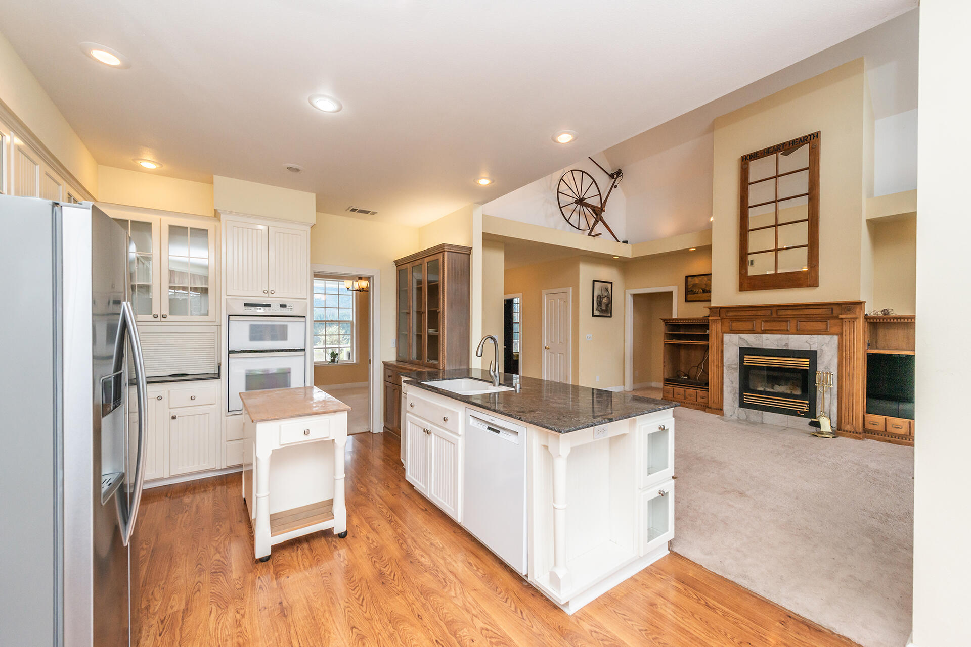 1551 Oak Ranch Road Lewiston, CA 96052 - Photo 28 of 35 a large kitchen with stainless steel appliances a stove a refrigerator a oven and white cabinets with wooden floor