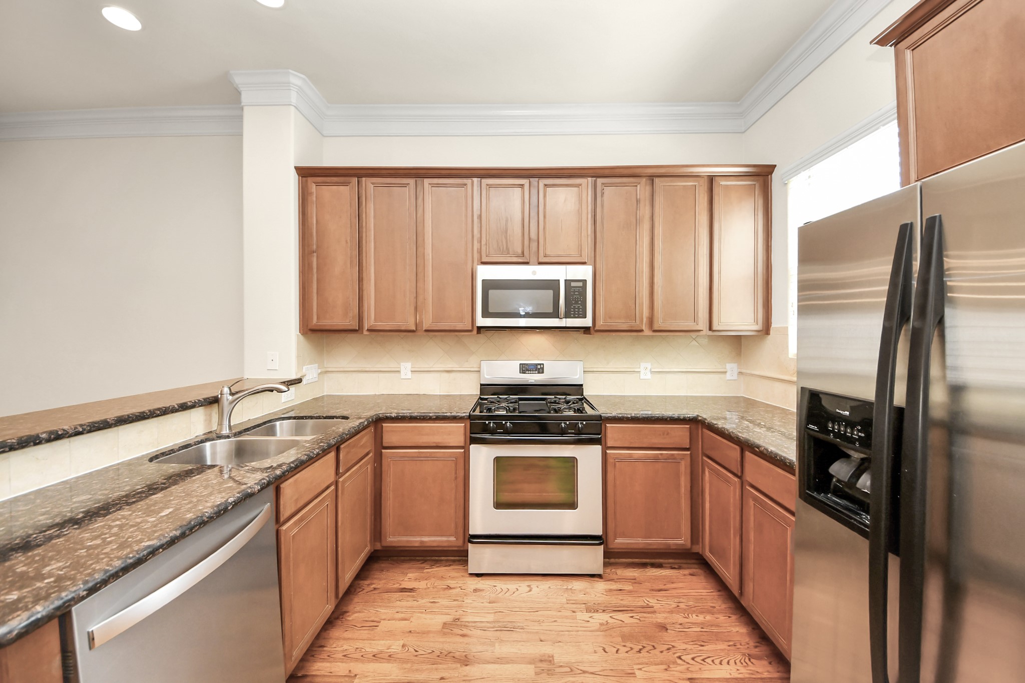 3422 Center Street Houston, TX 77007 - Photo 7 of 27 Functional kitchen has gas range and stainless appliances with a perfectly framed window to let light shine in. Fridge included here!
