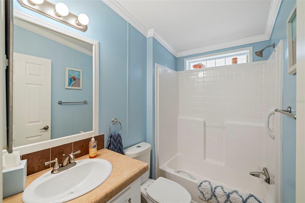 27 Freeman Avenue Punta Gorda, FL 33950 - Photo 13 of 32 a bathroom with a sink toilet a mirror and shower