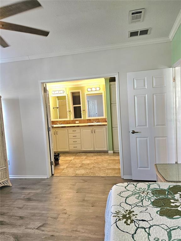 27 Freeman Avenue Punta Gorda, FL 33950 - Photo 18 of 32 a view of a bedroom with a bed and wooden floor