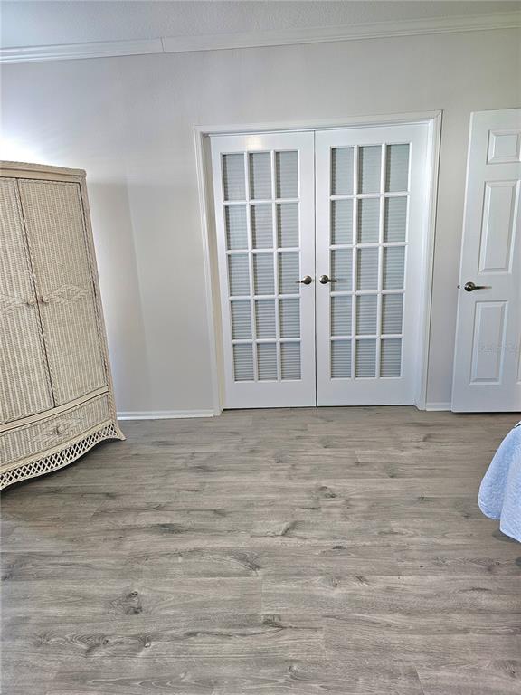 27 Freeman Avenue Punta Gorda, FL 33950 - Photo 19 of 32 a view of an empty room with wooden floor and cabinet