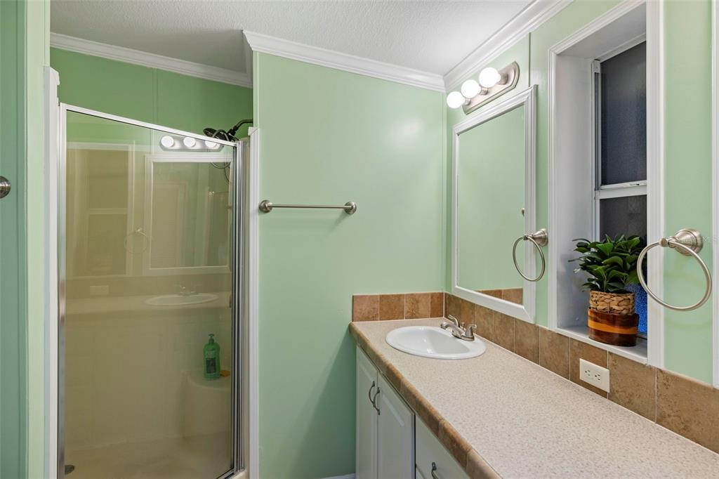 27 Freeman Avenue Punta Gorda, FL 33950 - Photo 21 of 32 a bathroom with a tub sink and mirror