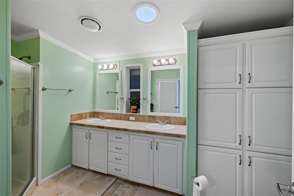 27 Freeman Avenue Punta Gorda, FL 33950 - Photo 22 of 32 a spacious bathroom with a granite countertop sink and a mirror
