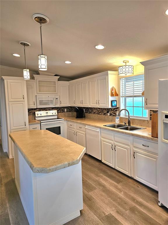 27 Freeman Avenue Punta Gorda, FL 33950 - Photo 7 of 32 a kitchen with stainless steel appliances granite countertop a sink dishwasher a refrigerator and a stove with wooden floor