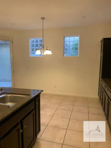 a kitchen with a sink a counter top space and cabinets