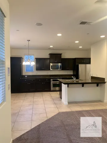 a kitchen with stainless steel appliances granite countertop a sink counter space and cabinets