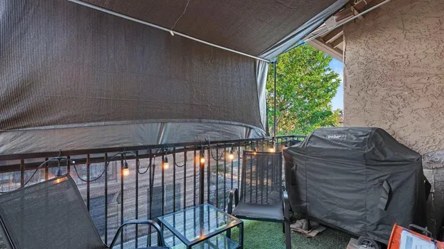 a view of balcony with two chairs and a table