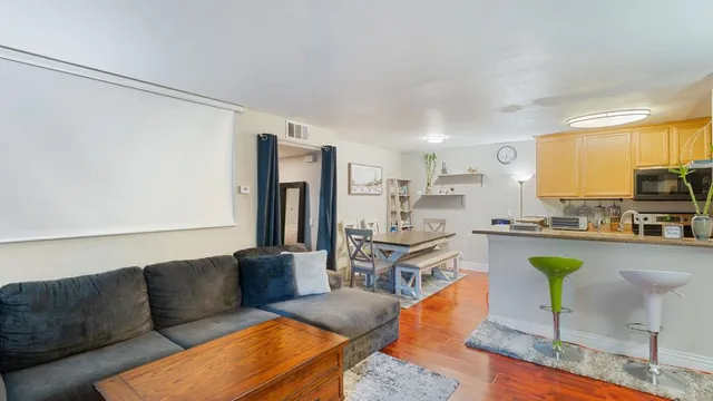 a living room with furniture and a kitchen view