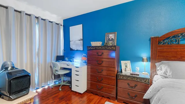 a bedroom with a bed and a dresser