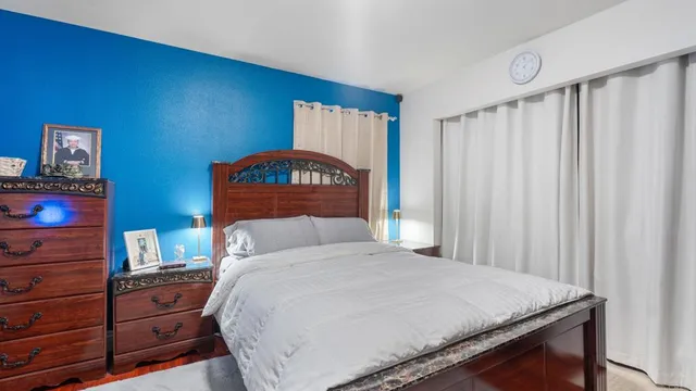 a bedroom with a bed and a dresser