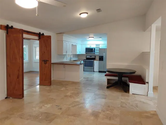 a room with dining table and chairs