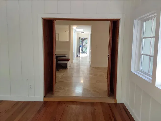 a view of a hallway with wooden floor