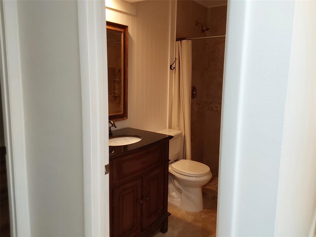 722 Wentworth Street Sebastian, FL 32958 - Photo 9 of 13 a bathroom with a granite countertop sink toilet and a mirror