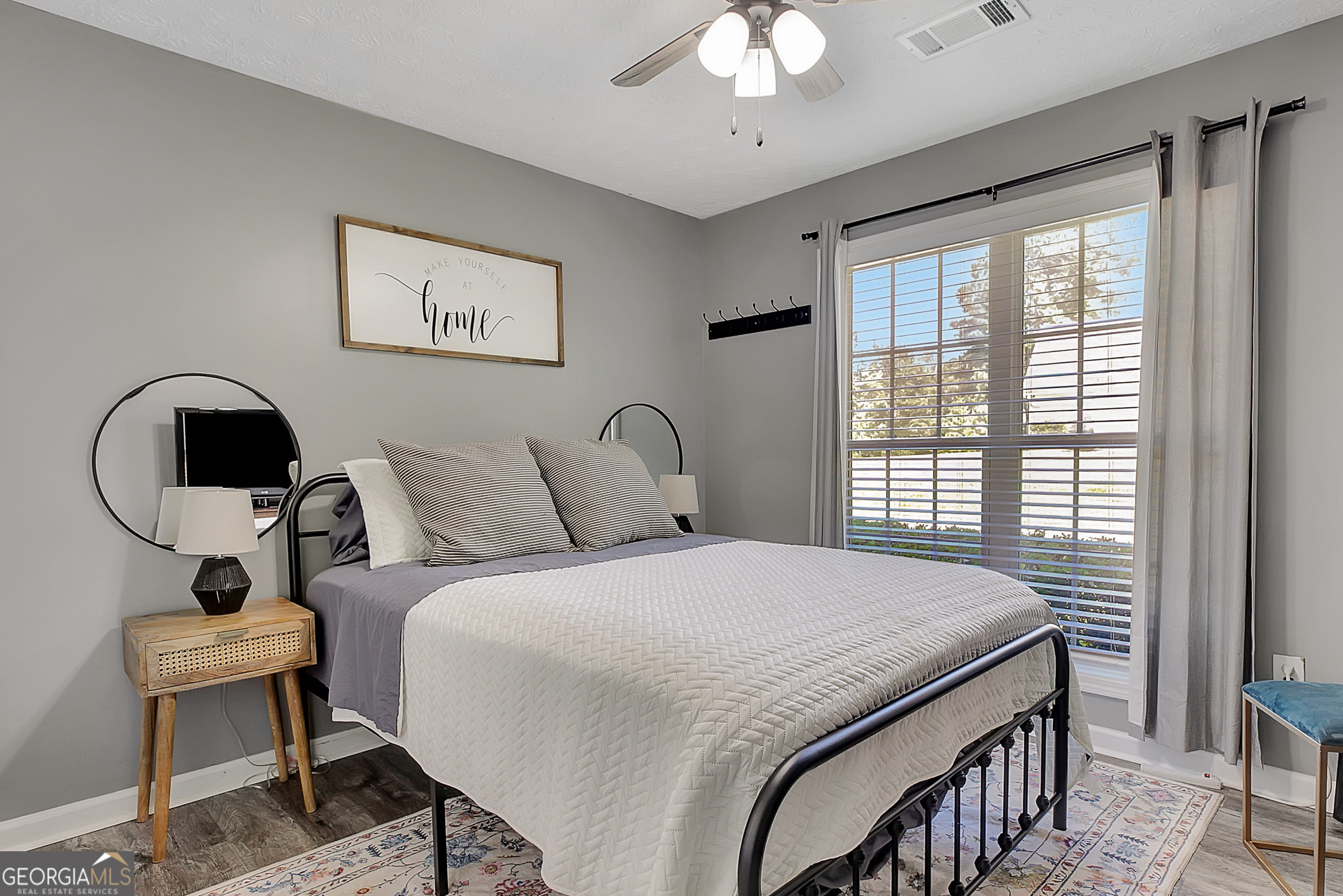 229 John Lovelace Road LaGrange, GA 30241 - Photo 36 of 59 a bedroom with a bed and a chandelier