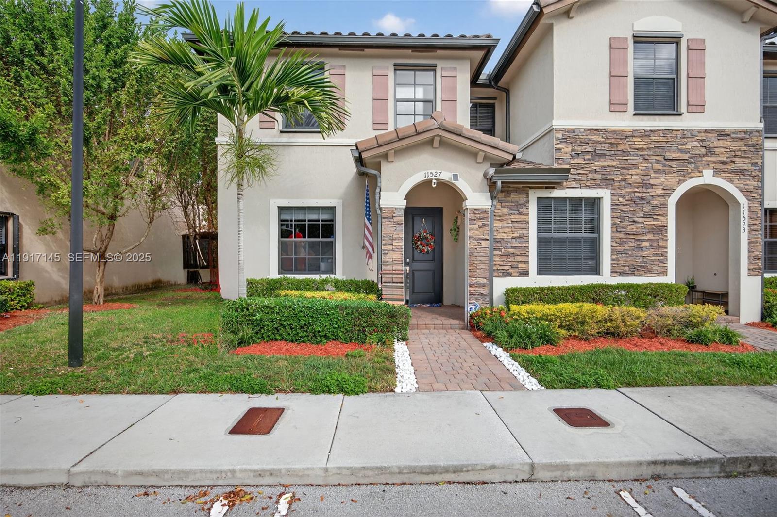 11527 Southwest 248th Lane Homestead, FL 33032 - Photo 1 of 44 a front view of a house with a garden and plants