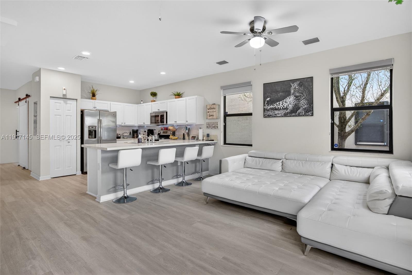 11527 Southwest 248th Lane Homestead, FL 33032 - Photo 11 of 44 a living room with furniture and kitchen view