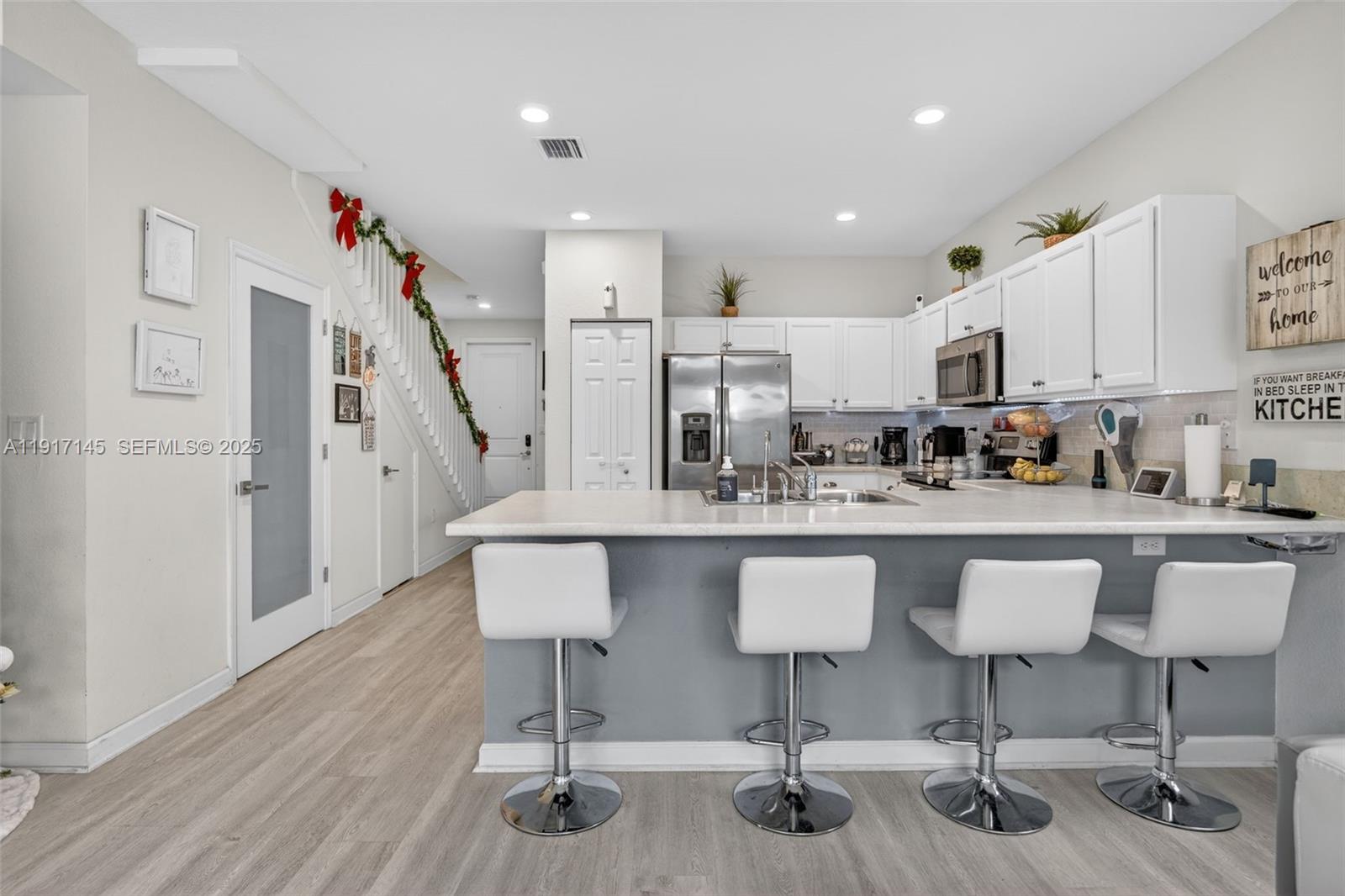 11527 Southwest 248th Lane Homestead, FL 33032 - Photo 12 of 44 a kitchen with stainless steel appliances granite countertop a white cabinets and chairs