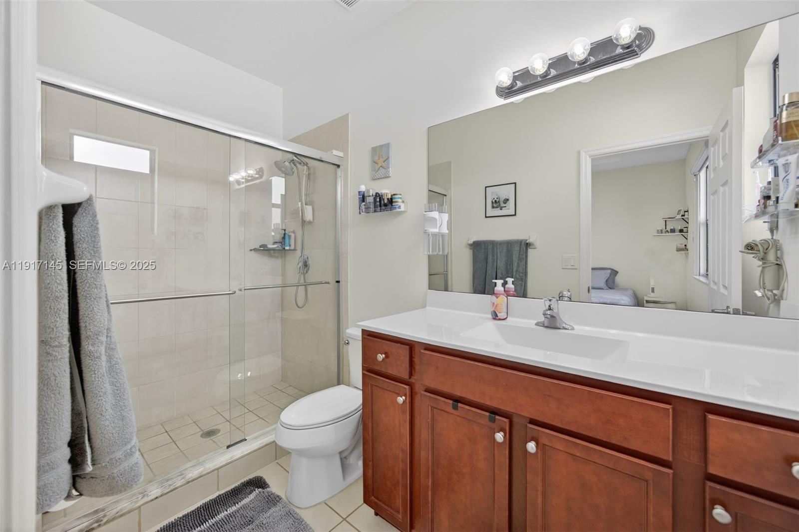 11527 Southwest 248th Lane Homestead, FL 33032 - Photo 19 of 44 a bathroom with a sink a toilet and shower