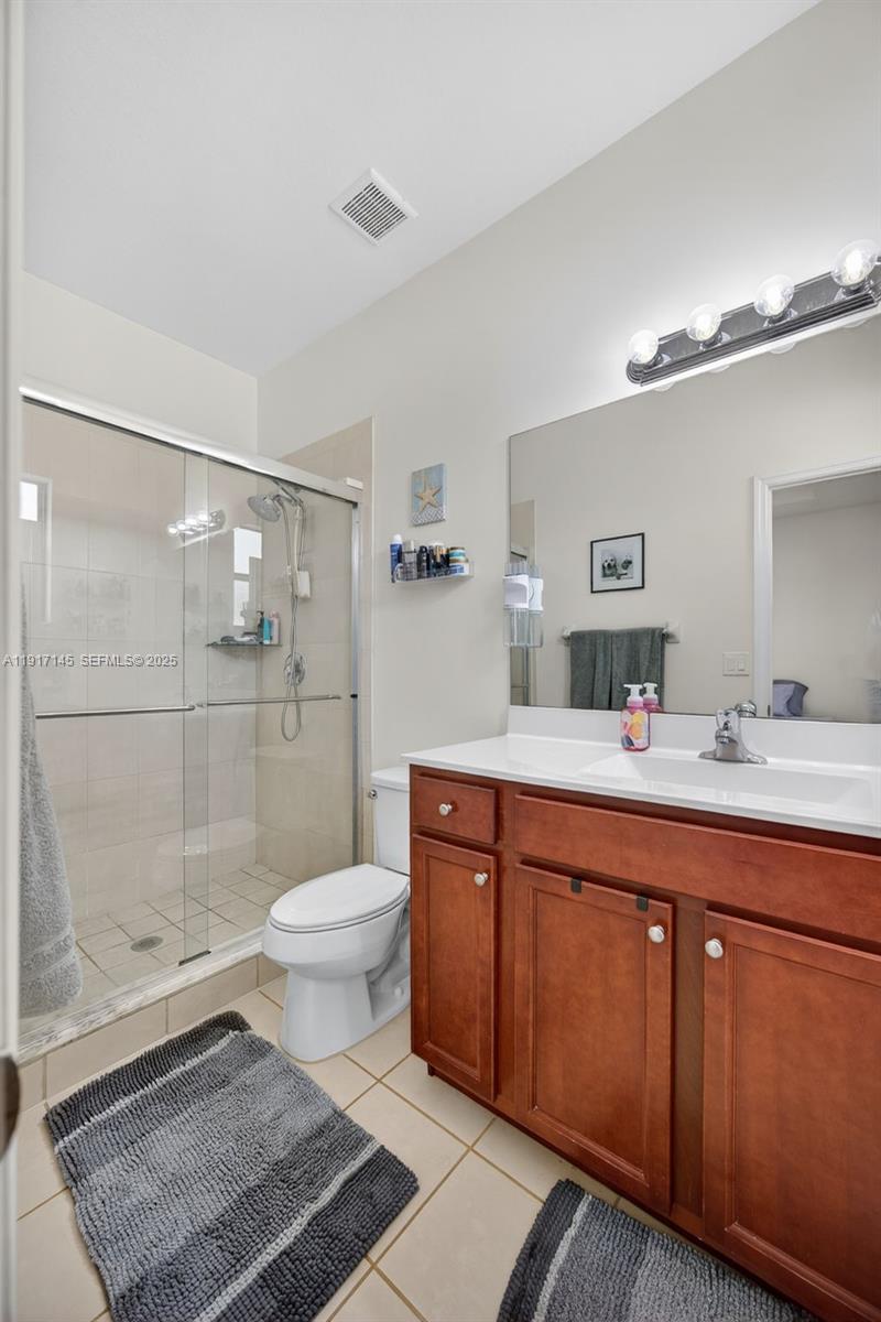 11527 Southwest 248th Lane Homestead, FL 33032 - Photo 20 of 44 a bathroom with a sink toilet a mirror and shower