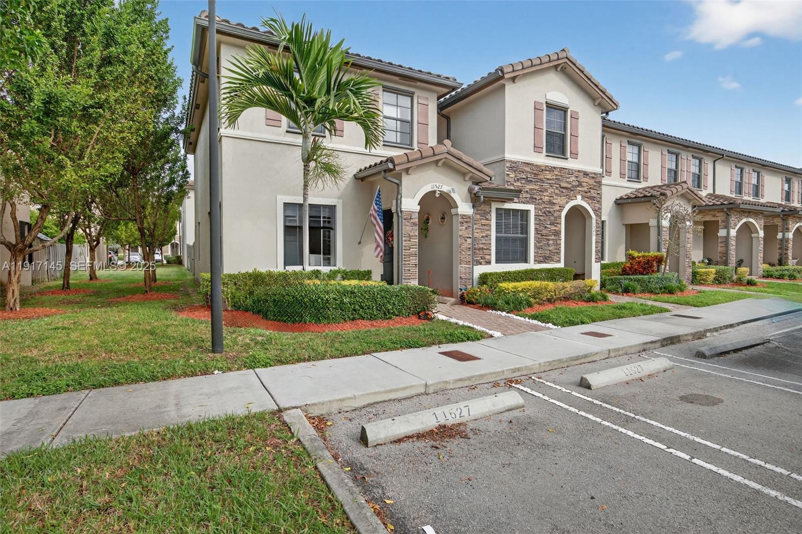 11527 Southwest 248th Lane Homestead, FL 33032 - Photo 2 of 44 a front view of a house with a yard and trees
