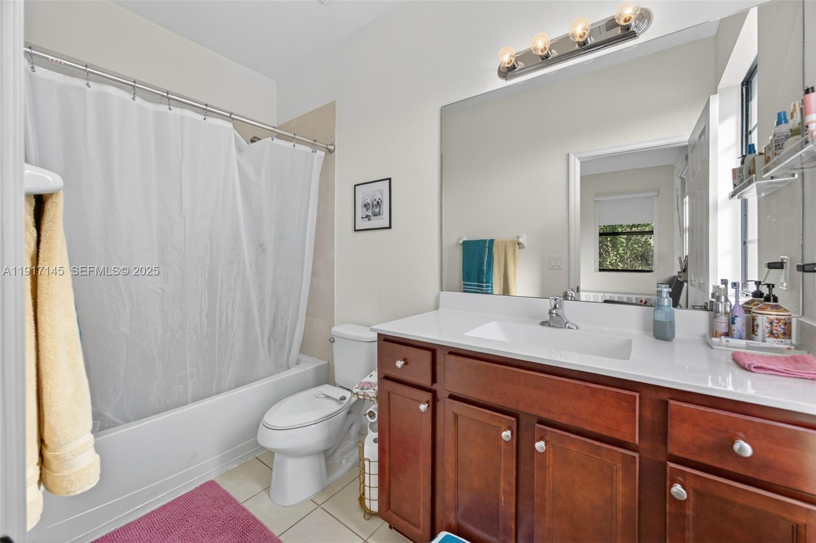 11527 Southwest 248th Lane Homestead, FL 33032 - Photo 25 of 44 a spacious bathroom with a granite countertop sink toilet a mirror a vanity and shower