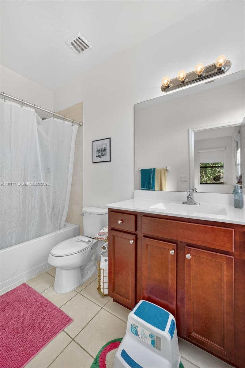 11527 Southwest 248th Lane Homestead, FL 33032 - Photo 26 of 44 a bathroom with a sink a toilet a mirror a vanity and shower