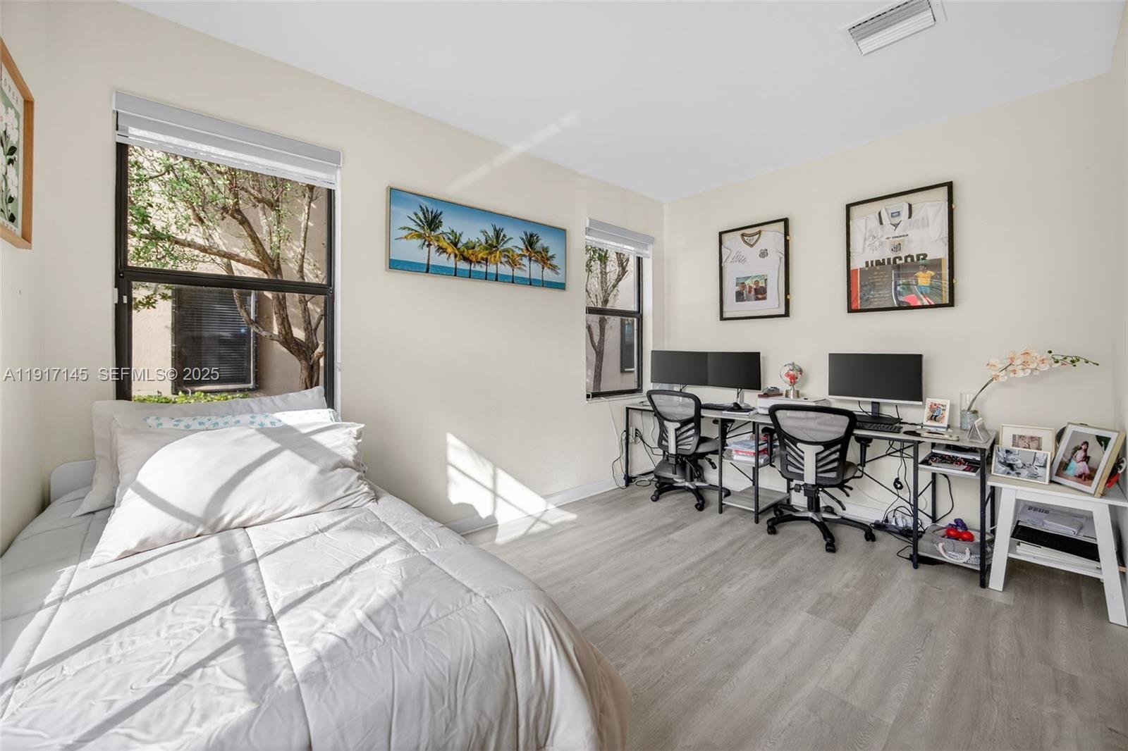 11527 Southwest 248th Lane Homestead, FL 33032 - Photo 28 of 44 a bedroom with furniture and a wooden floor