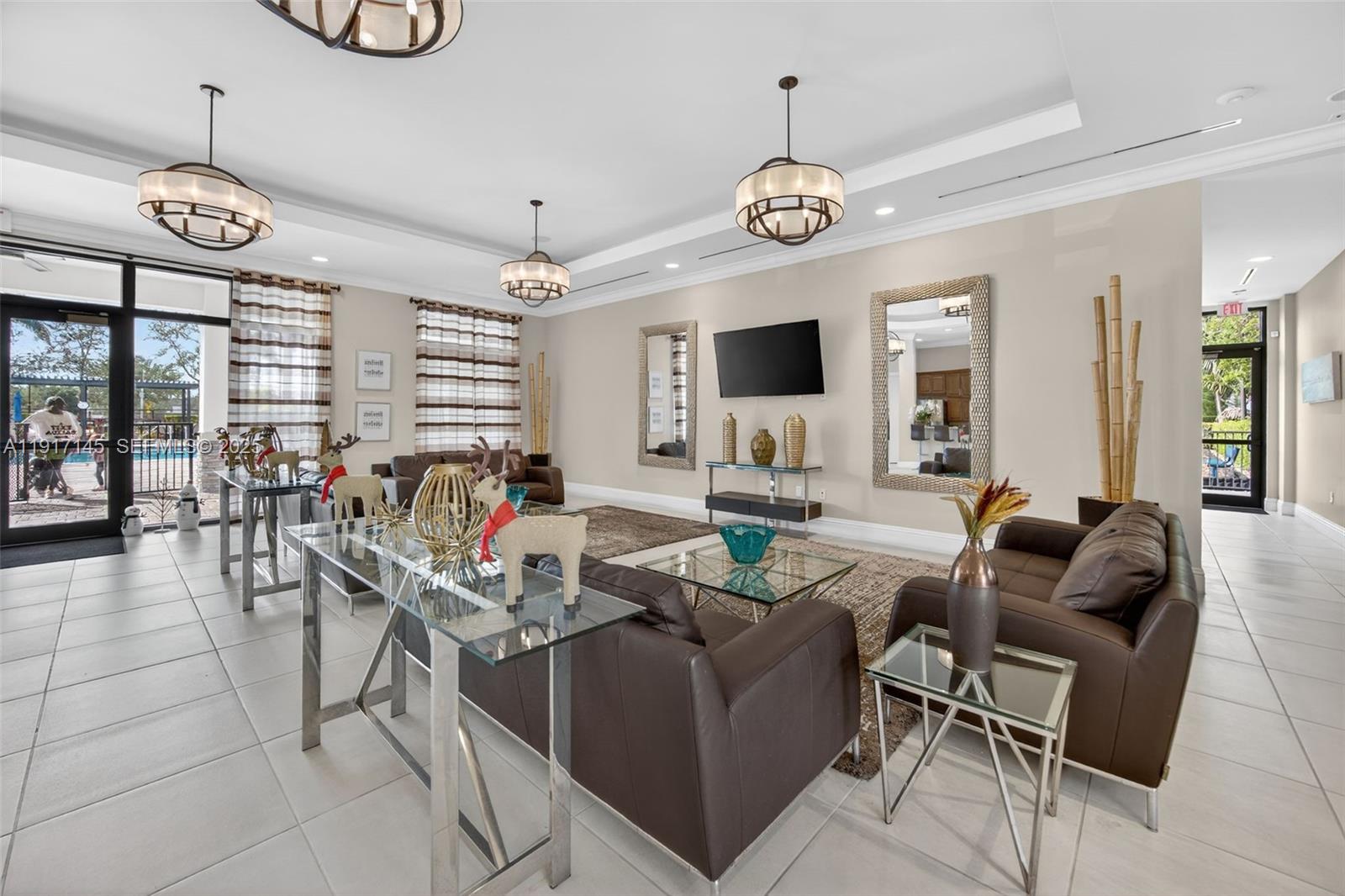 11527 Southwest 248th Lane Homestead, FL 33032 - Photo 35 of 44 a living room with furniture a large window and a chandelier