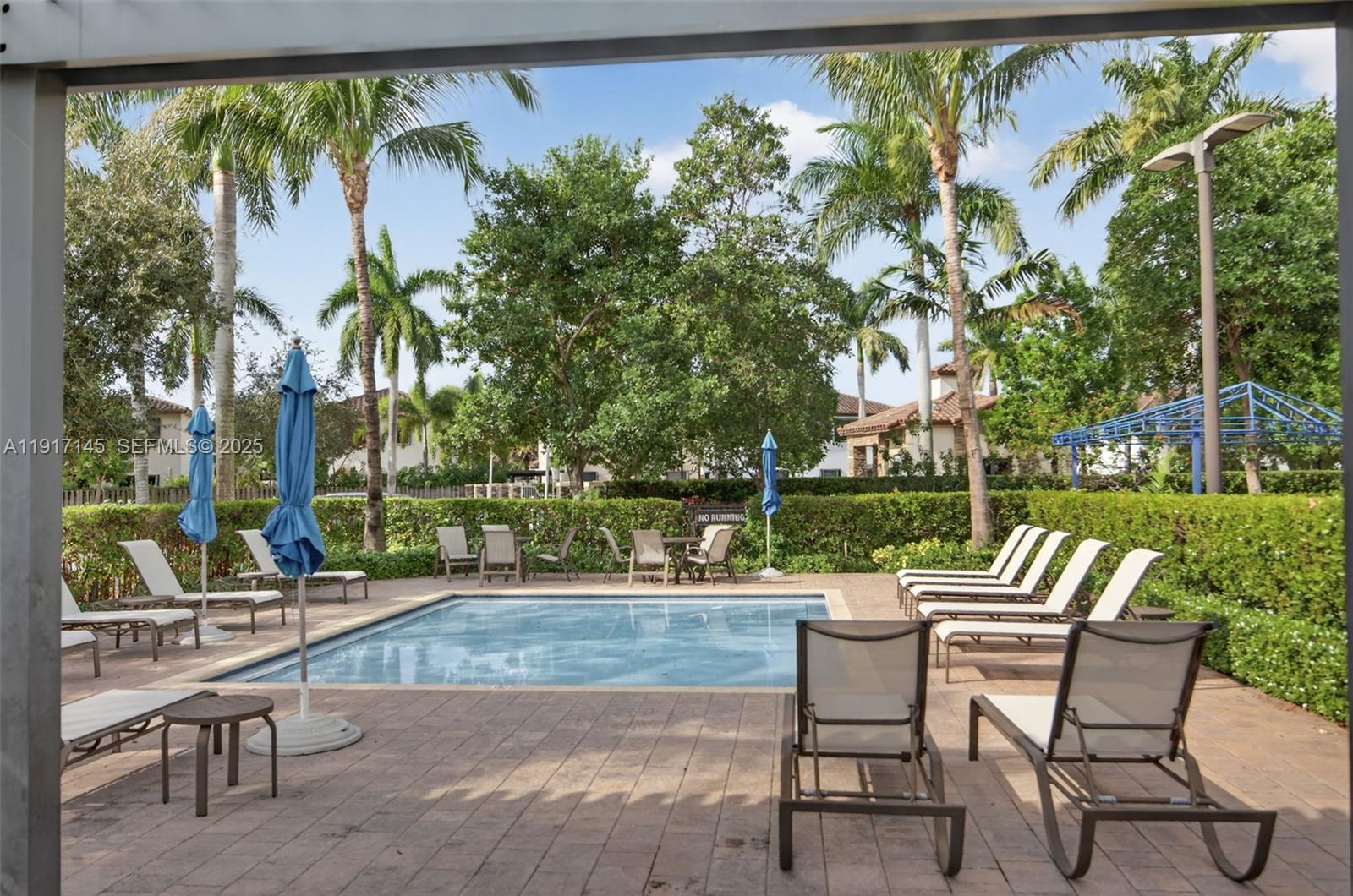 11527 Southwest 248th Lane Homestead, FL 33032 - Photo 42 of 44 an outdoor sitting area with furniture and a garden