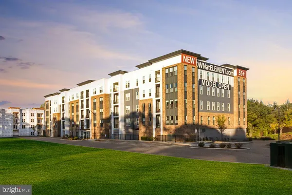 a view of an apartment building and a yard