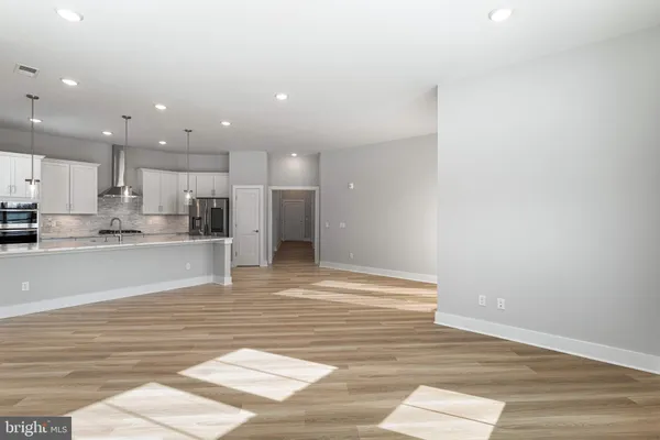 a view of kitchen view with cabinets and wooden floor