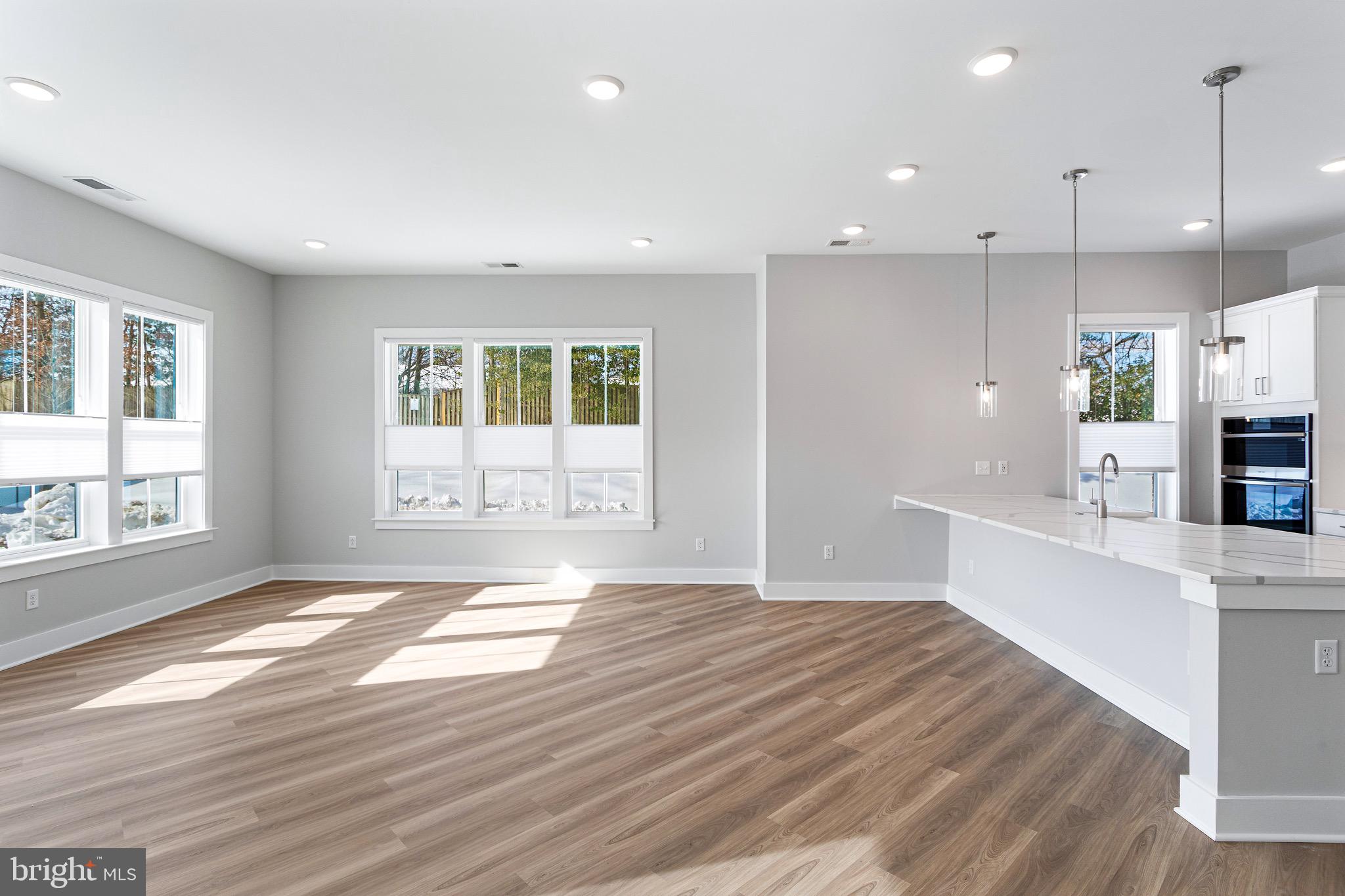 76 Old Mill Bottom Road North, Unit 102 Annapolis, MD 21409 - Photo 20 of 42 a view of an empty room with window and wooden floor