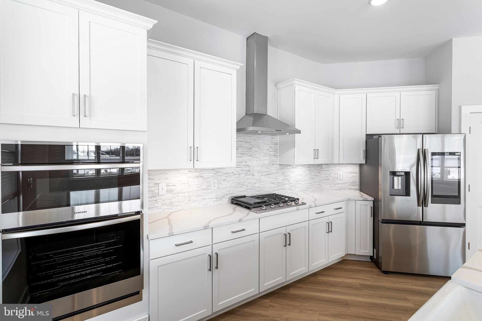 76 Old Mill Bottom Road North, Unit 102 Annapolis, MD 21409 - Photo 23 of 42 a kitchen with stainless steel appliances white cabinets and a stove top oven