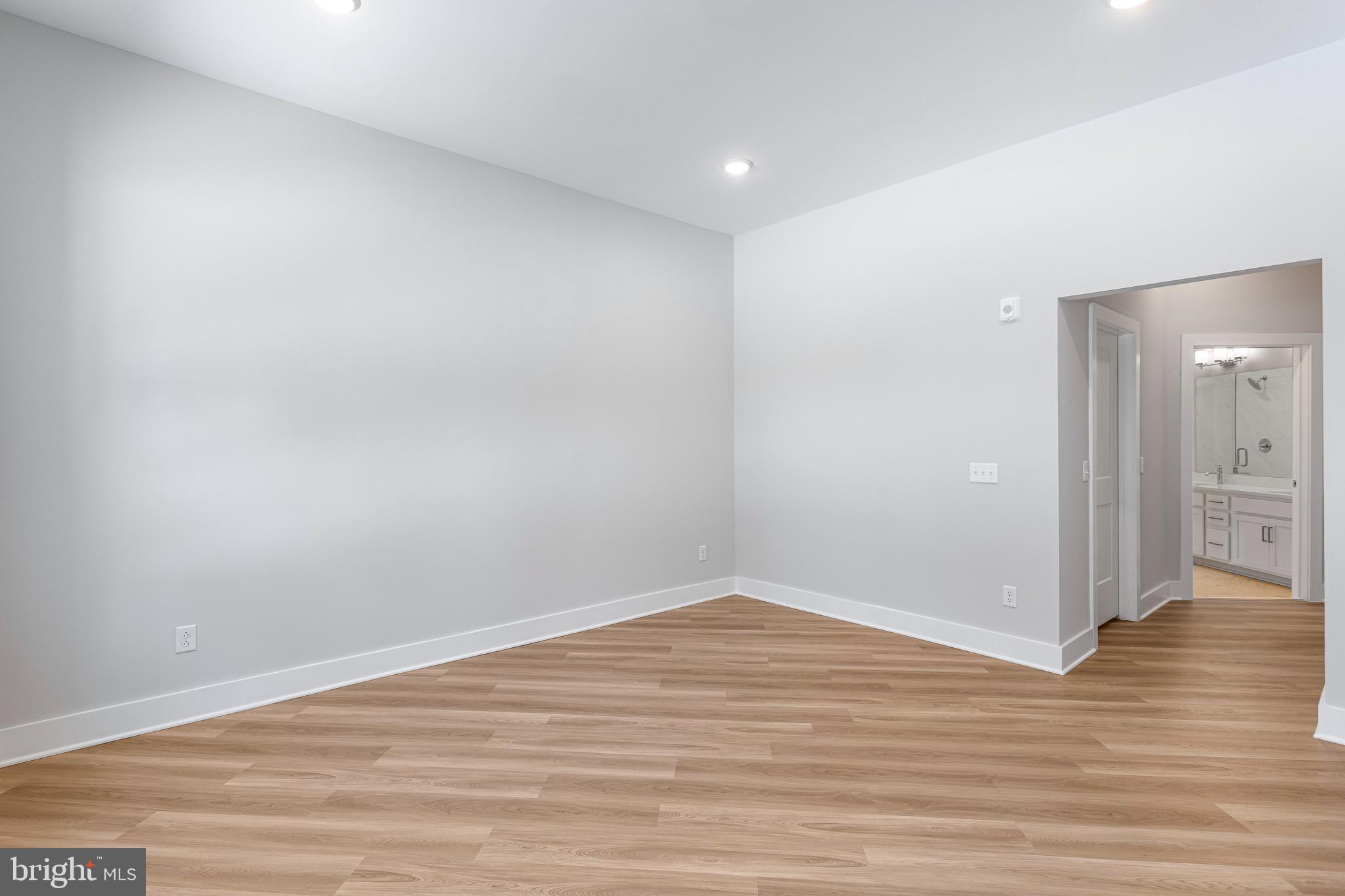 76 Old Mill Bottom Road North, Unit 102 Annapolis, MD 21409 - Photo 26 of 42 a view of an empty room with wooden floor and a bathroom