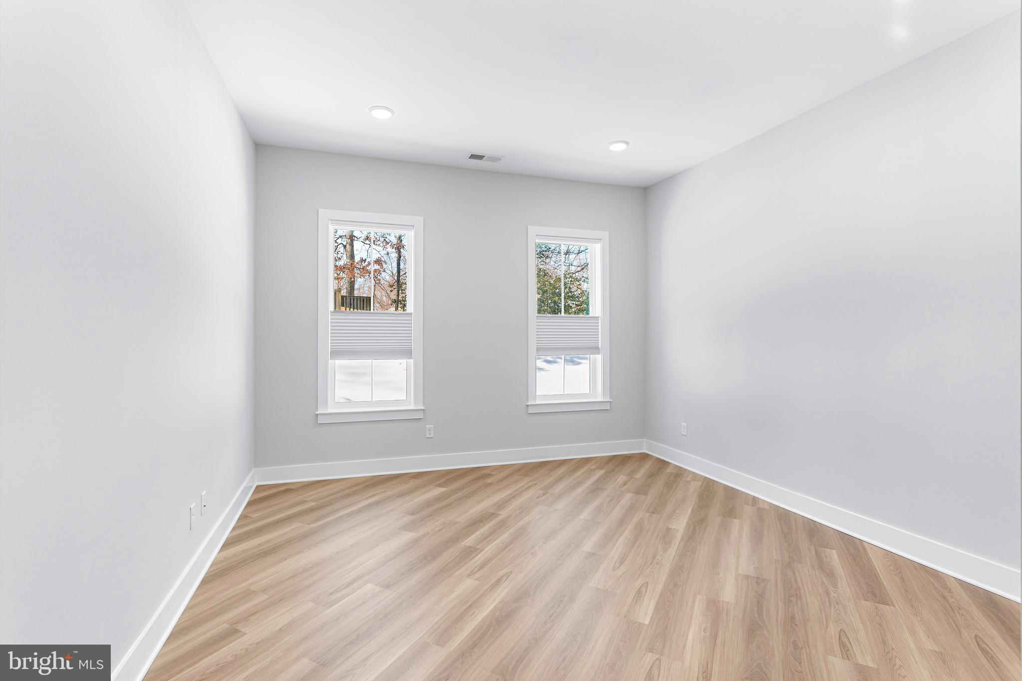 76 Old Mill Bottom Road North, Unit 102 Annapolis, MD 21409 - Photo 27 of 42 an empty room with wooden floor and windows
