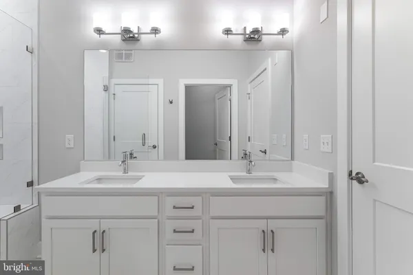 a bathroom with a sink vanity and a mirror