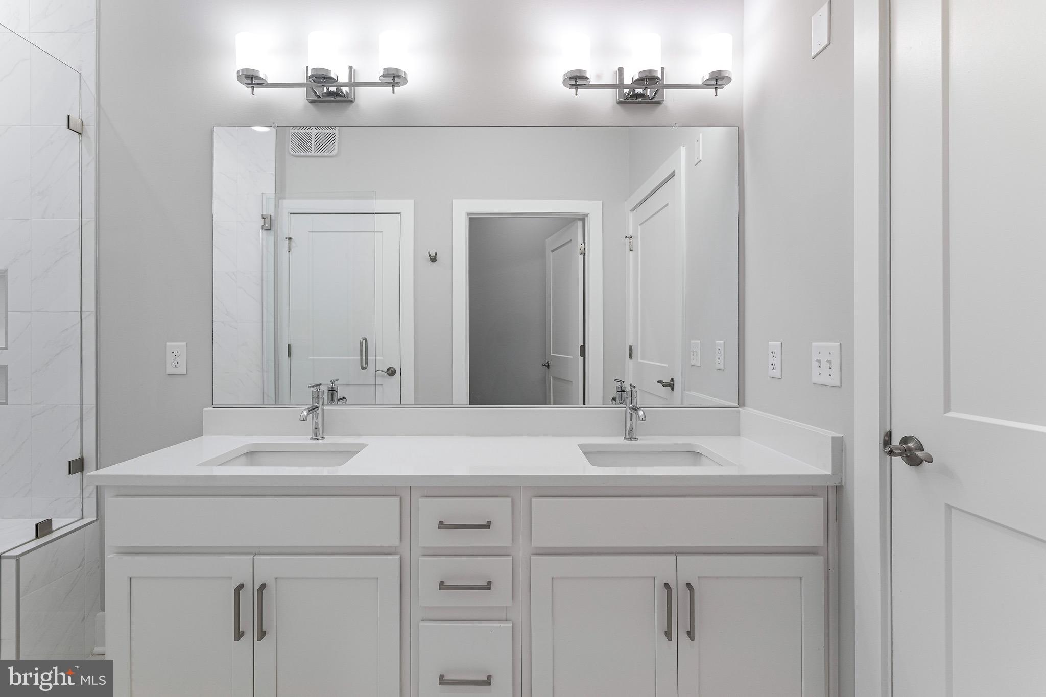 76 Old Mill Bottom Road North, Unit 102 Annapolis, MD 21409 - Photo 29 of 42 a bathroom with a sink vanity and a mirror
