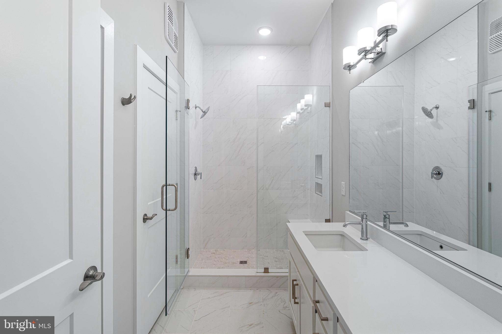 76 Old Mill Bottom Road North, Unit 102 Annapolis, MD 21409 - Photo 30 of 42 a bathroom with a double vanity sink mirror and shower