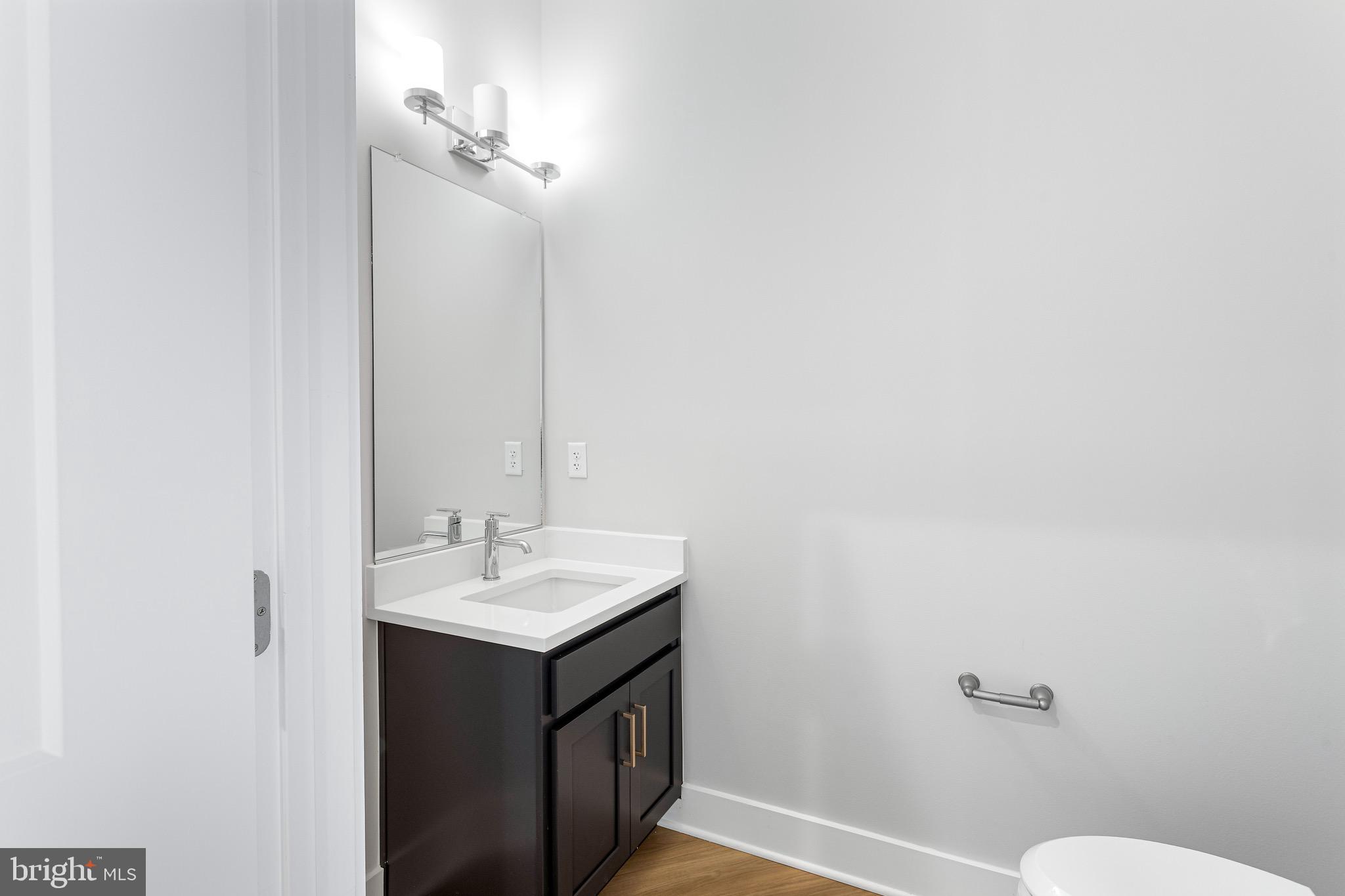 76 Old Mill Bottom Road North, Unit 102 Annapolis, MD 21409 - Photo 31 of 42 a bathroom with a sink vanity and a mirror