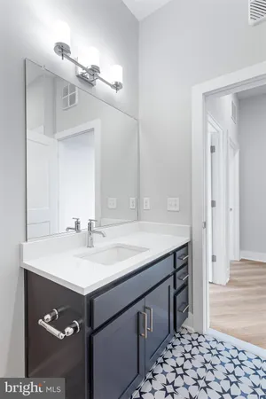 a bathroom with a sink vanity and a mirror