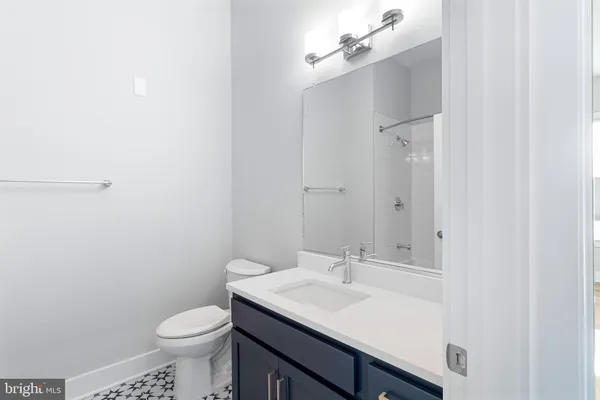 a bathroom with a sink toilet and a mirror