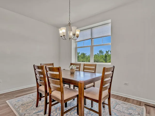 a view of a dining room with a table and chairs