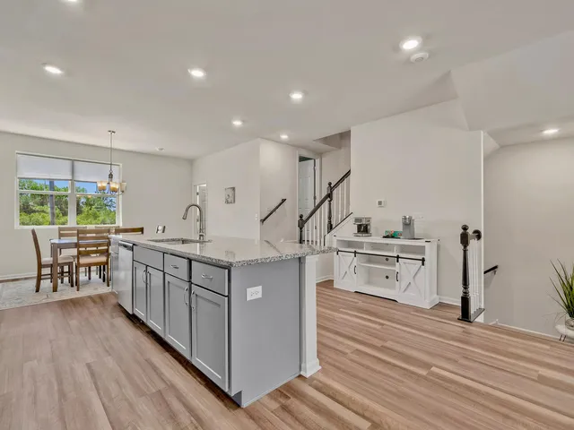 a kitchen with stainless steel appliances a stove and more cabinets