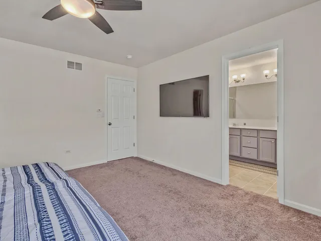 a view of a livingroom with an empty space & a ceiling fan