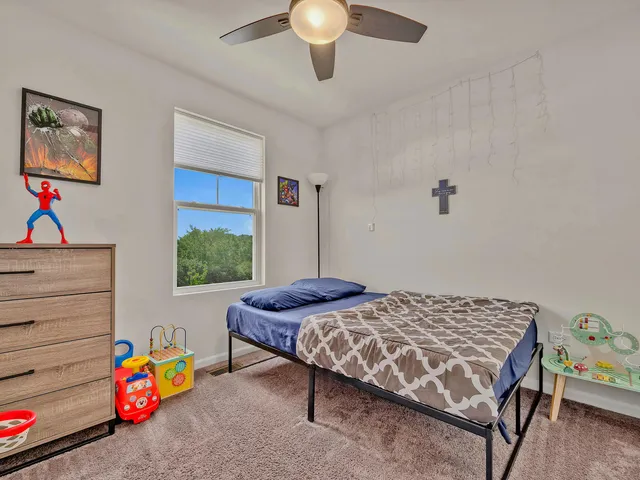 a bedroom with a bed and a dresser in it