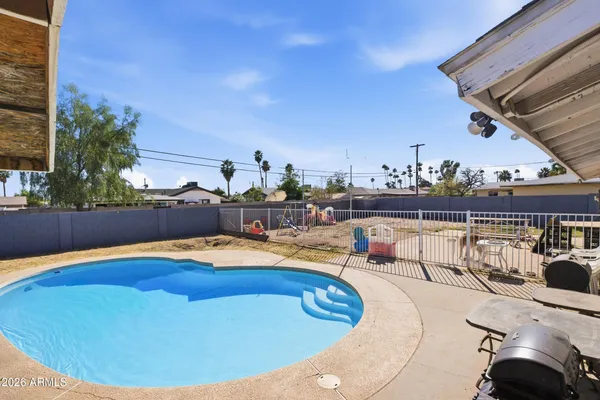 a view of a swimming pool with lounge chairs