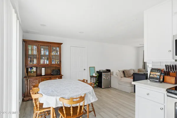a dining room with furniture and wooden floor